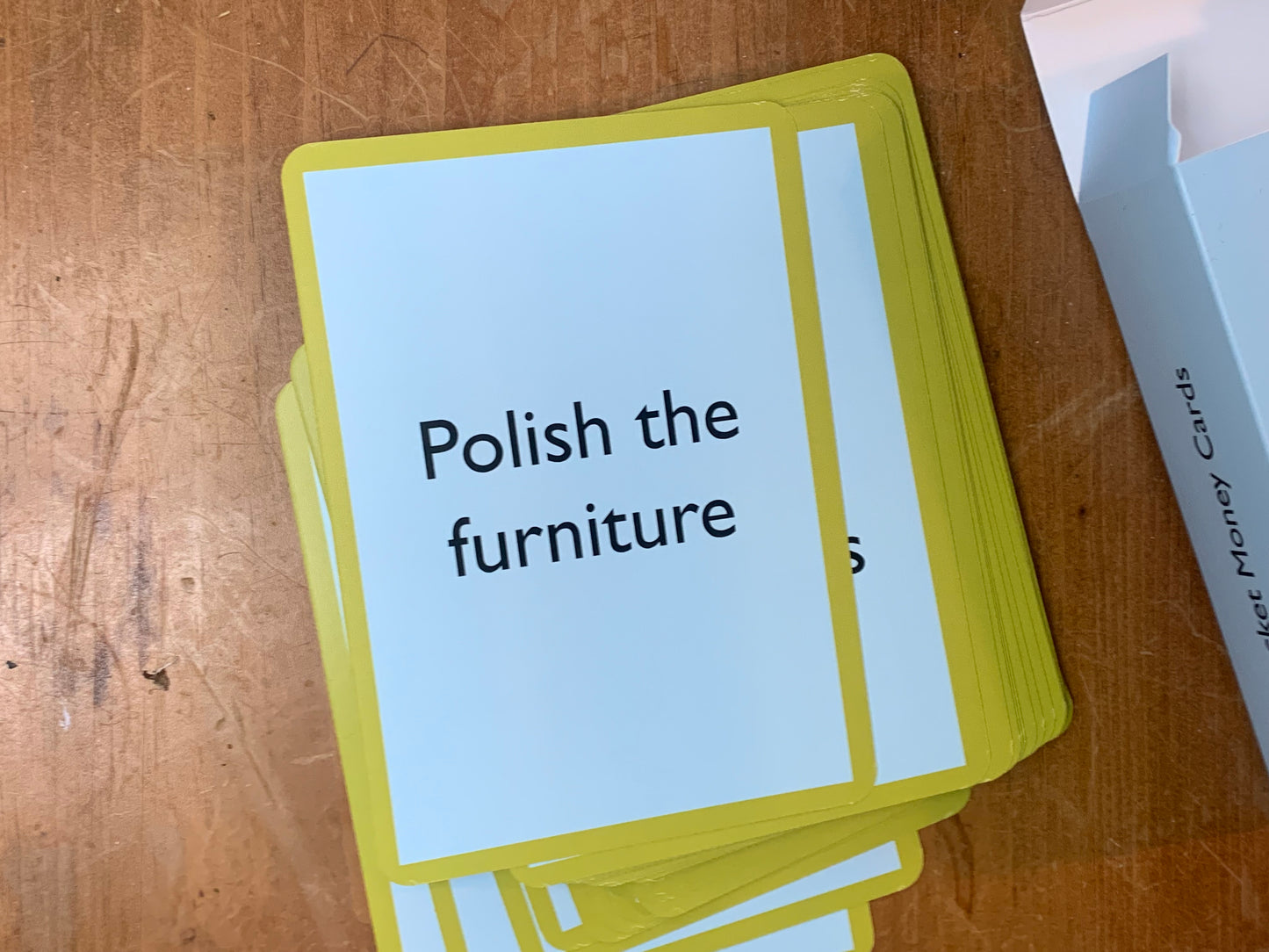 a Pocket Money Card showing the text: Polish the furniture.