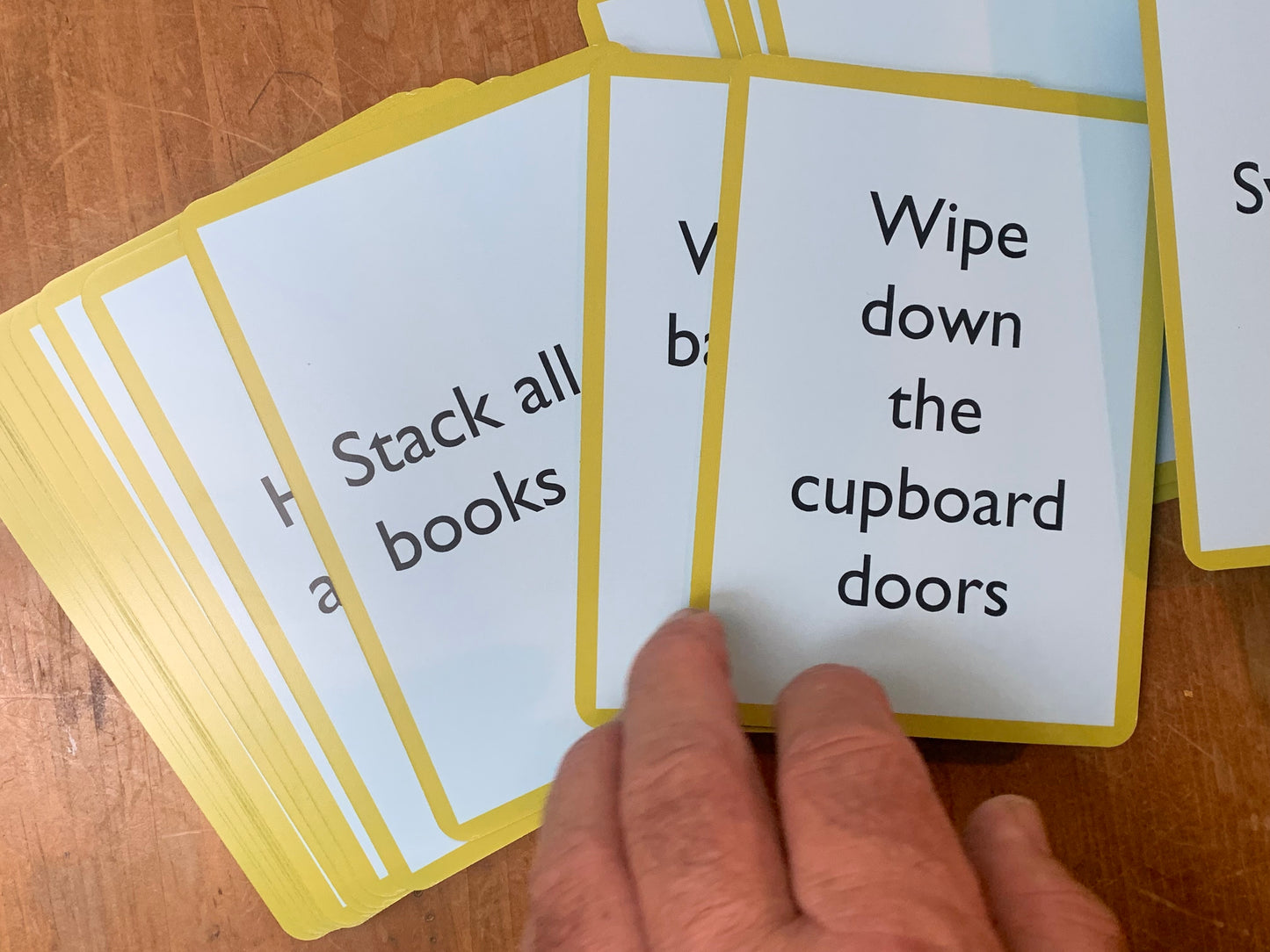 A Pocket Money Card bearing the text: Wipe down the cupboard doors.