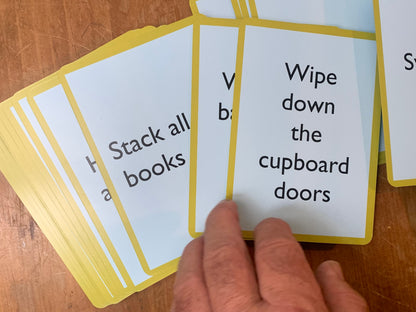 A Pocket Money Card bearing the text: Wipe down the cupboard doors.